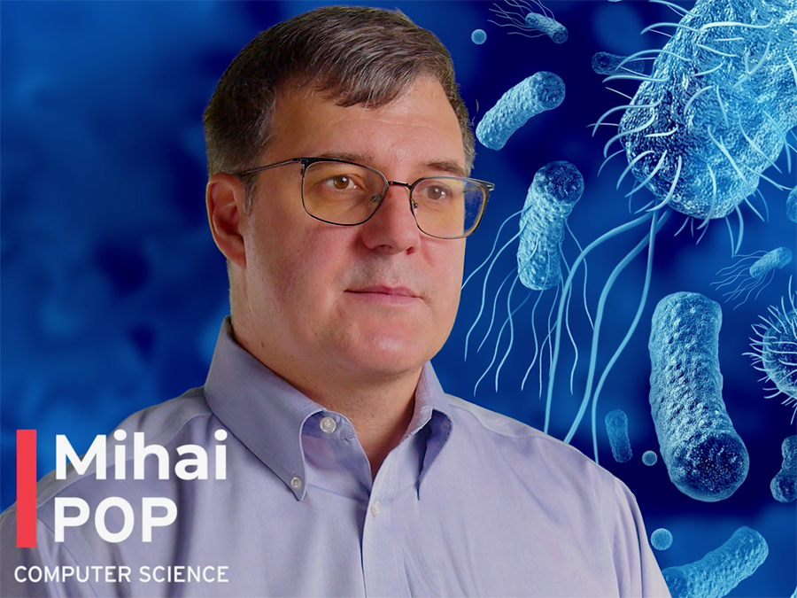 Mihai Pop against a deep blue tinted microscopy background of various microbes
