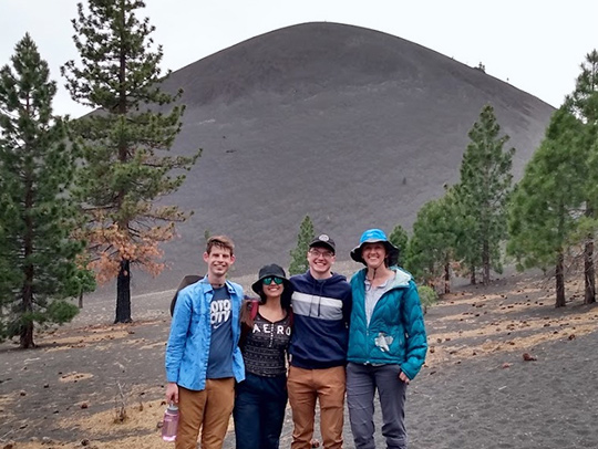 Geology graduate student Liam Peterson, recent graduate Silvia Castilla Montagut and graduate student Kyle Kim are pictured with Assistant Professor Megan Newcombe during a trip to sample volcanic tephra at Cinder Cone in California’s Lassen Volcanic National Park. Photo courtesy of Newcombe.