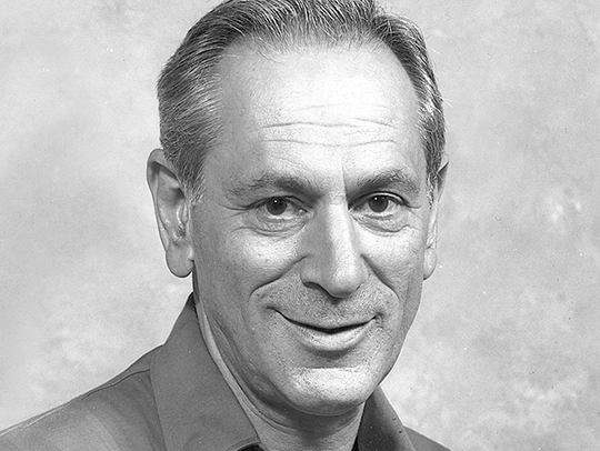 A black and white photo of Jack Minker