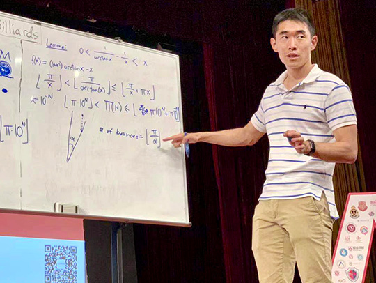 Andrew Guo giving a presentation at a whiteboard