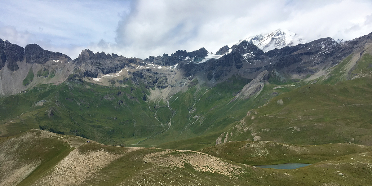 Dramatic mountains, green valley and a lake from Ollomont, in the Italian Alps