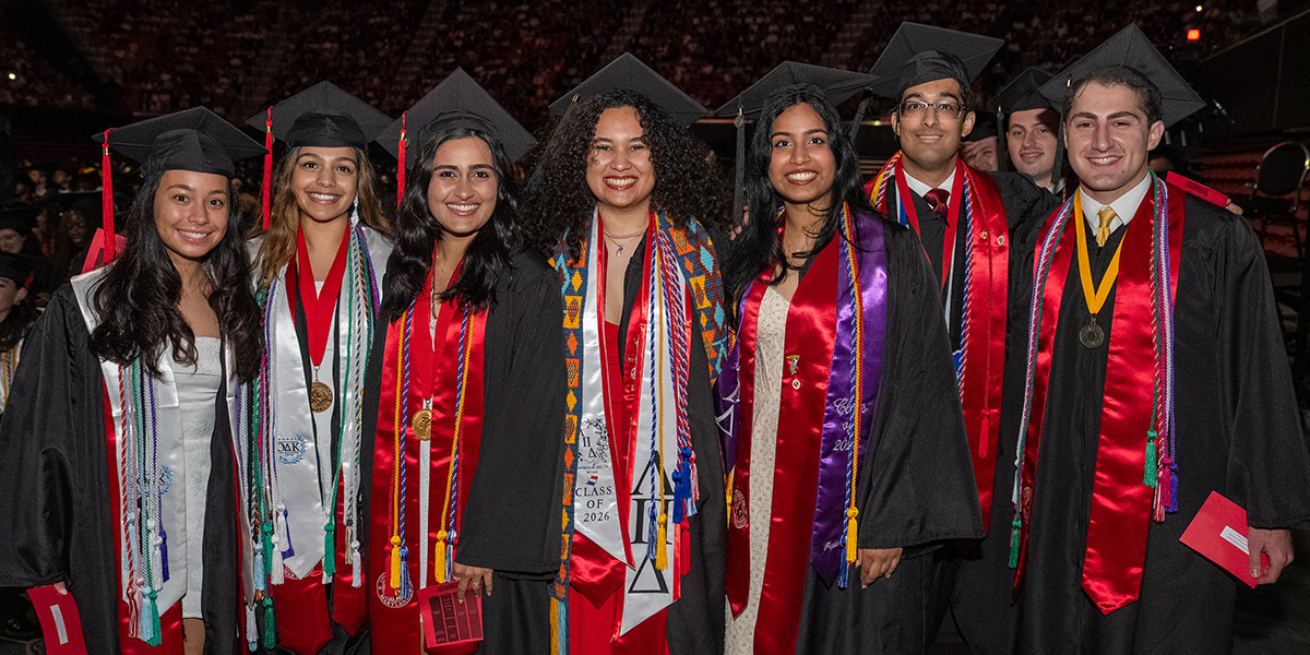 A group of undergraduates in regalia, including sashes, medals and cords, at Commencement. Credit: Mark Sherwood.