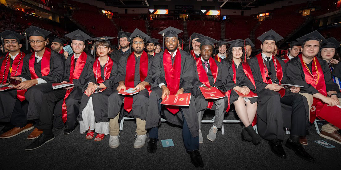 Part of the front row of students at the 2024 undergraduate commencement ceremony, wearing caps and gowns. Credit: Mark Sherwood.