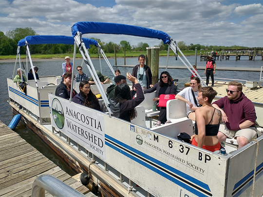 A group of UMD biological sciences majors on a boat for a field trip with the Anacosta Watershed Society