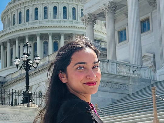Vainavi Gambhir standing outside with the U.S. Capitol in the background