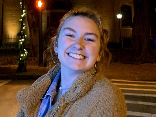 Shannon Ganley in a night-time photo with bright lights in the background