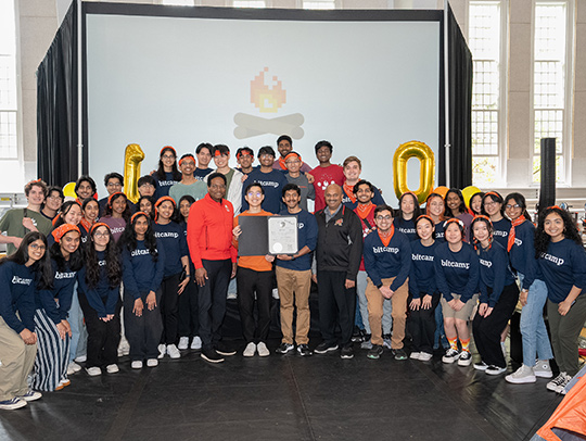 A large group of students and mentor at the 2024 Bitcamp. At the front and just off center are UMD President Darryll Pines and CMNS dean AMitabh Varshney.