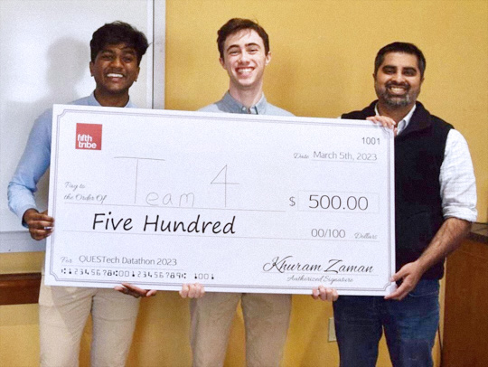 The winners of the QUESTTech competition holding a giant prize check