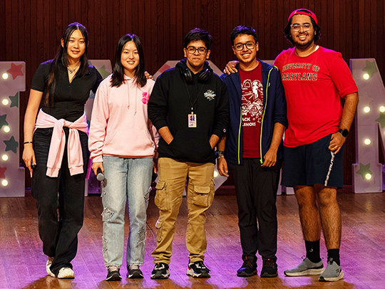 A group of people on stage at the awards ceremony at Hack MIT.