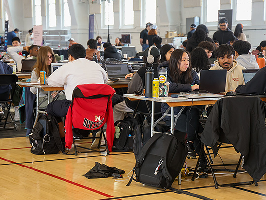 A large group of students working in teams on laptop computers at the 2025 Bitcamp Hackathon. A large group of students working in teams on laptop computers at the 2025 Bitcamp Hackathon.