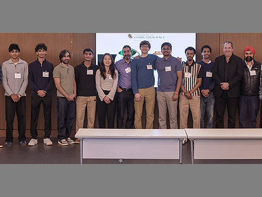 A large group of students and mentors on stage at the Hatchery Demo Day