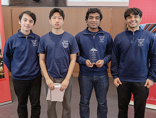 The first place programming contest team from Thomas Jefferson High School, Alexandria, Va. They are 4 young men, all wearing dark blue shirts with their school's logo on it.