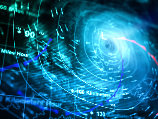 Stock image of a computer screen showing a hurricane with wind direction and speed indicators. Credit: iStock.