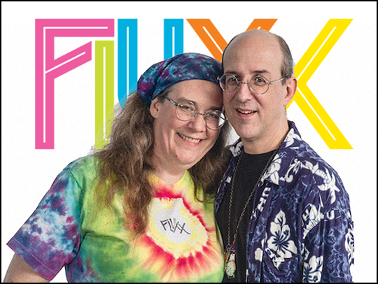 (L-R) Kristin and Any Looney, with the Fluxx logo in the background.