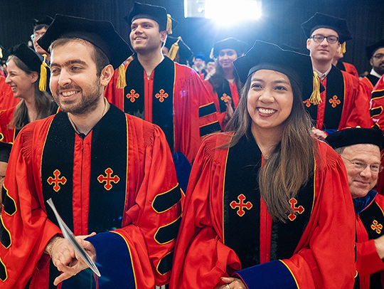 A crowd of celebrating Ph.D. students in regalia at the May 2025 commencement ceremony. Credit: Mark Sherwood.