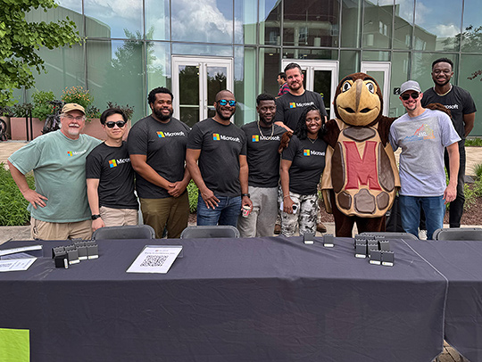 Group photo of Microsoft employees with Testudo, UMD students and faculty.