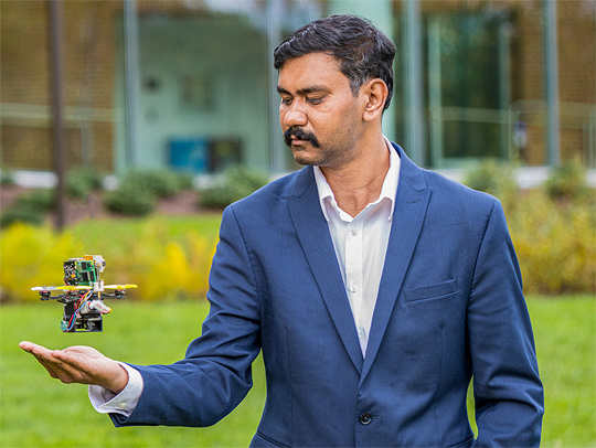 Nitin Sanket with a little drone hovering over his palm