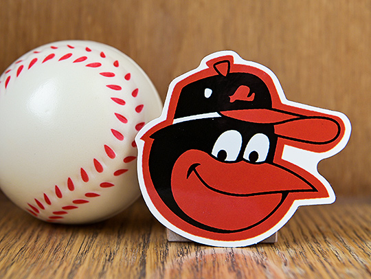 A baseball and a Baltimore Orioles logo. Credit: Adobe Stock