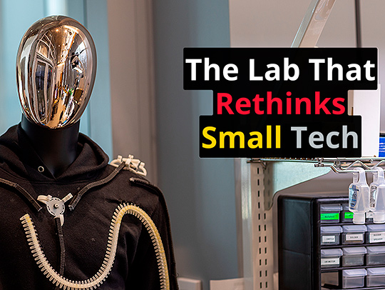 A mannequin with a chrome head dressed in wearable technology.