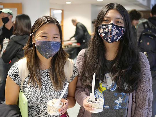 A pair of young women showing off their ice cream at the Ice Cream Social. Photo credit: Faye Levine