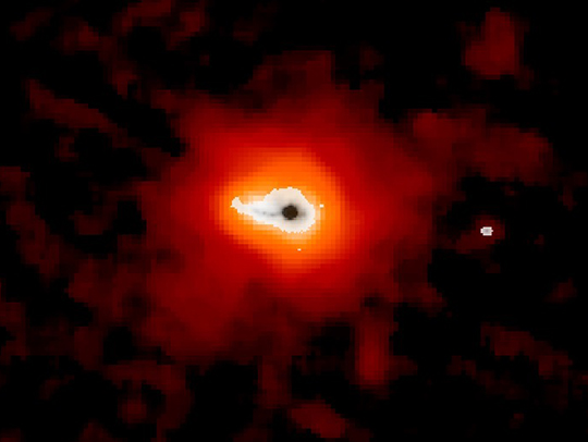 The Makani galaxy, with a cloud of warm red dust radiating out from it. Credit: Sylvain Veilleux, NASA.