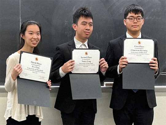 The top 3 winners of the high school math competition, holding their certificates.