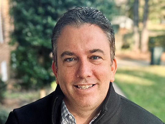 Bill Fahrbach sitting on a porch