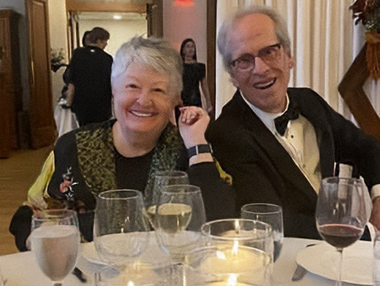 THe Levermores in formal dress at a party.