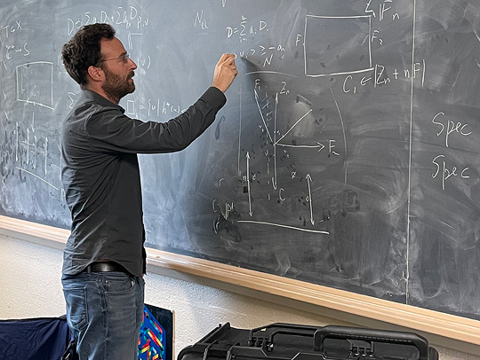 Yanir Rubinstein at a blackboard