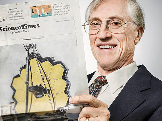 John Mather reading a New York Times story about the Webb Telescope. Photo Credit: NASA