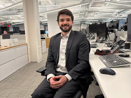 Nathan Frohna, wearing a suit, in the Morgan Stanley Office