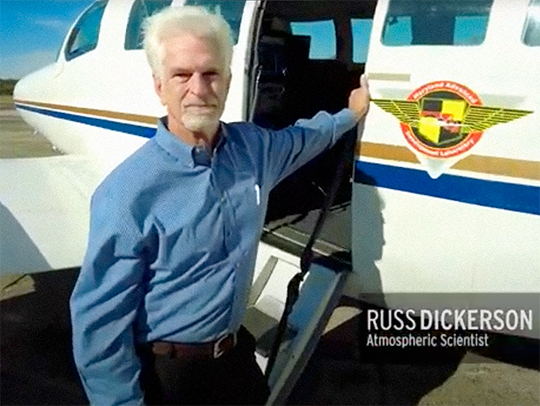 A video stil of Russ Dickerson leaning against a small plane