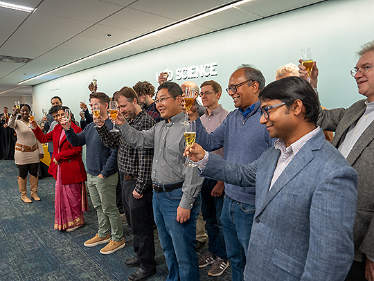A group of faculty members raising their glasses at the Tenure and Promotion Toast event. Credit: Mark Sherwood.