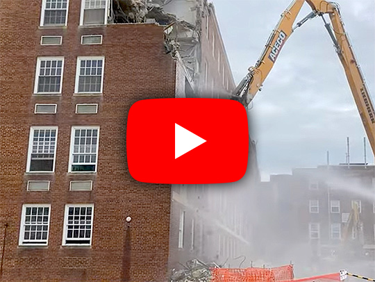 A video still with a play button, showing Chemistry Wing One being demolished.